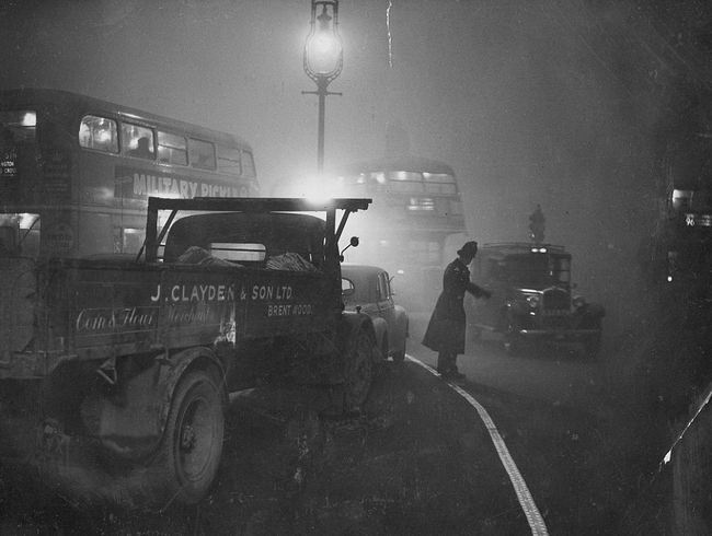 Outside the Bank of England, an officer keeping traffic moving through the Great Smog of London.